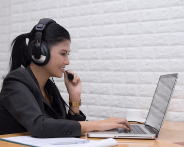 A professional transcriptionist hearing an audio and typing on a computer keyboard.