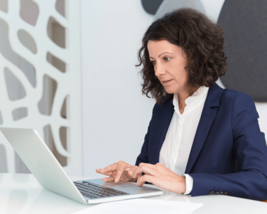 A typist applies a formatting pass during Typing Services, using quality control notes to match the manuscript layout.
