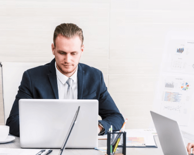 A native experts using a laptop in an office, representing typing services for precise document handling.