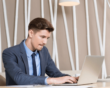 A expert typing on a laptop at his office, showcasing experienced typing services with a high accuracy rate of 99%.