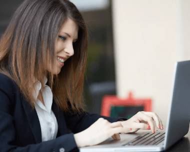 A woman working on a laptop, reflecting specialized typing services to meet industry-specific document requirements.