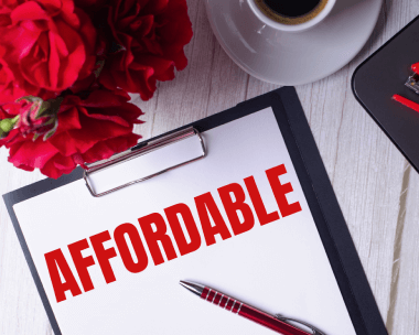 Affordable written in red on a notepad next to a laptop, symbolizing cost-effective typing services for various documents.